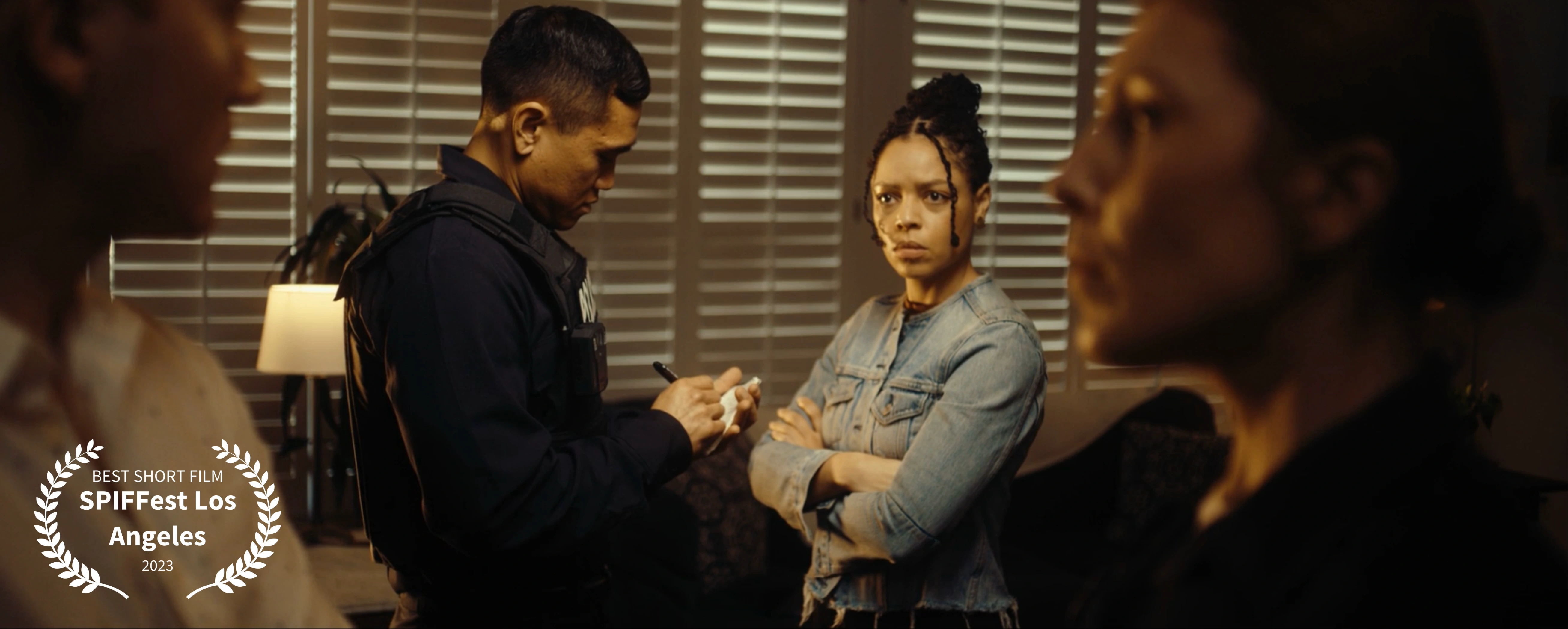 A young woman surrounded by police officers inside her home