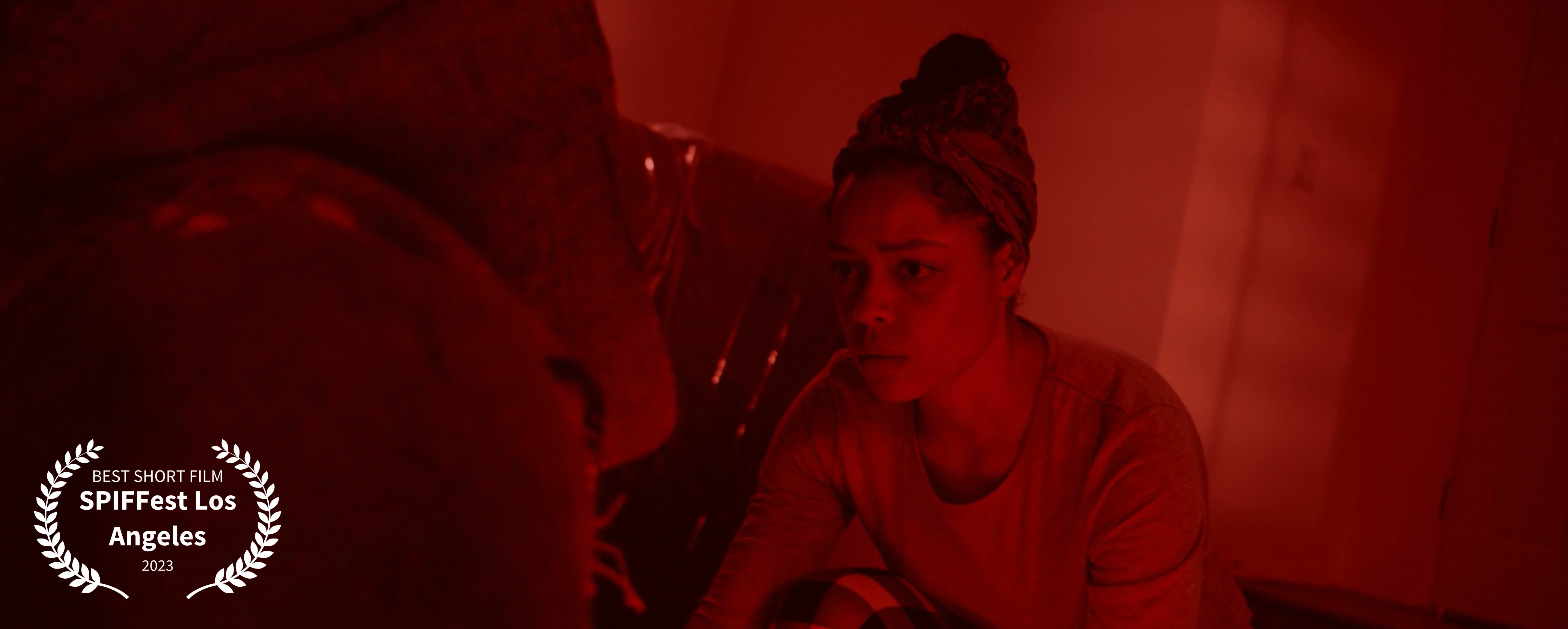 A young woman confronting an uninvited guest in red light