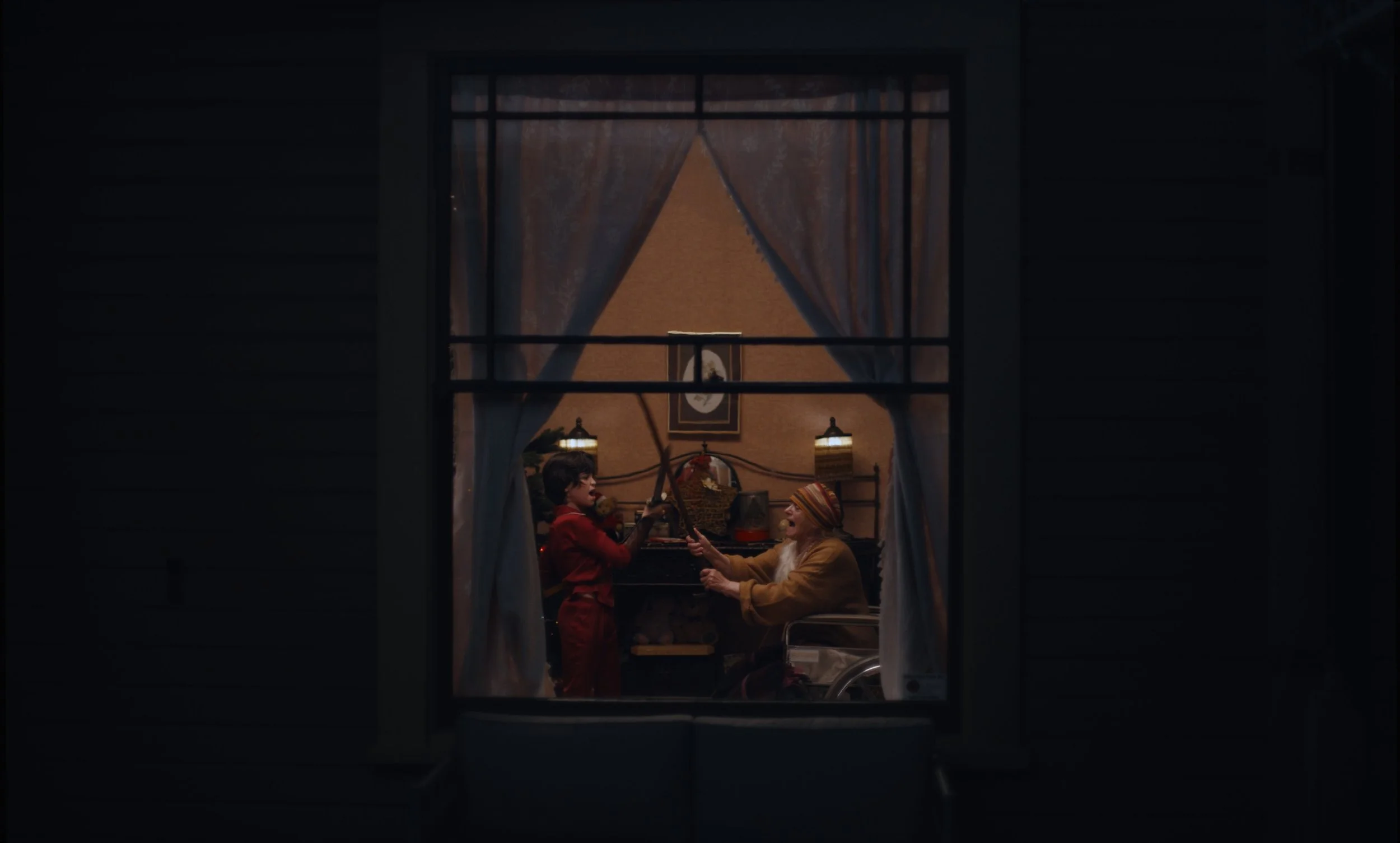 Toby and his nana seen through a window